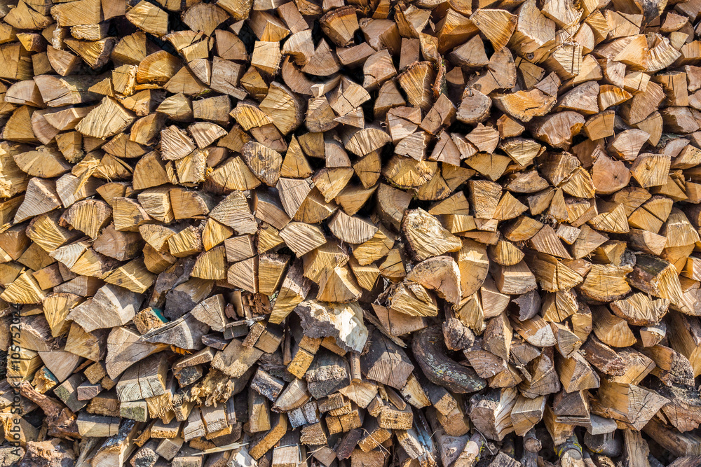 Stacked logs of fire wood background.