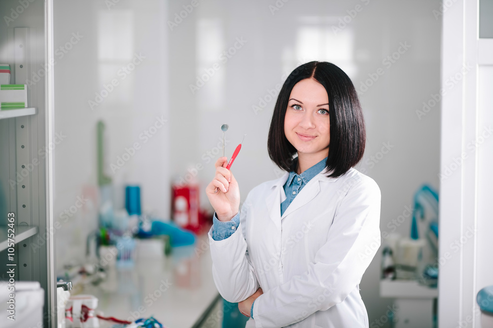 Young beautiful girl - dentist prepares the tooth to treat the patient. Young beautiful girl - dentist prepares the tooth to treat the patient.