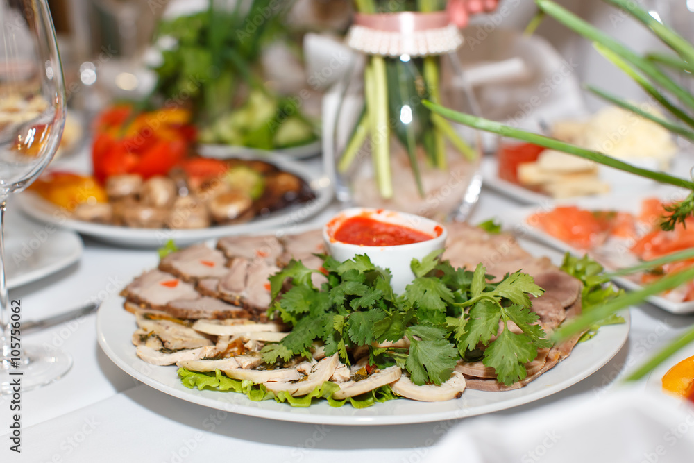 Cutting the meat, tongue, parsley and sauce on a white plate Clo Cutting the meat, tongue, parsley and sauce on a white plate Clo