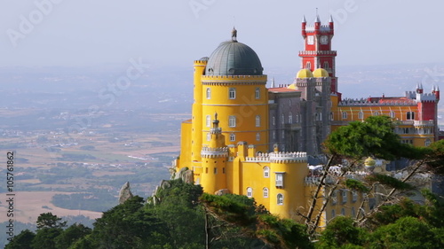 Portugal. Sintra. The Pena Palace on a cliff surrounded by forest. Sunny and windy