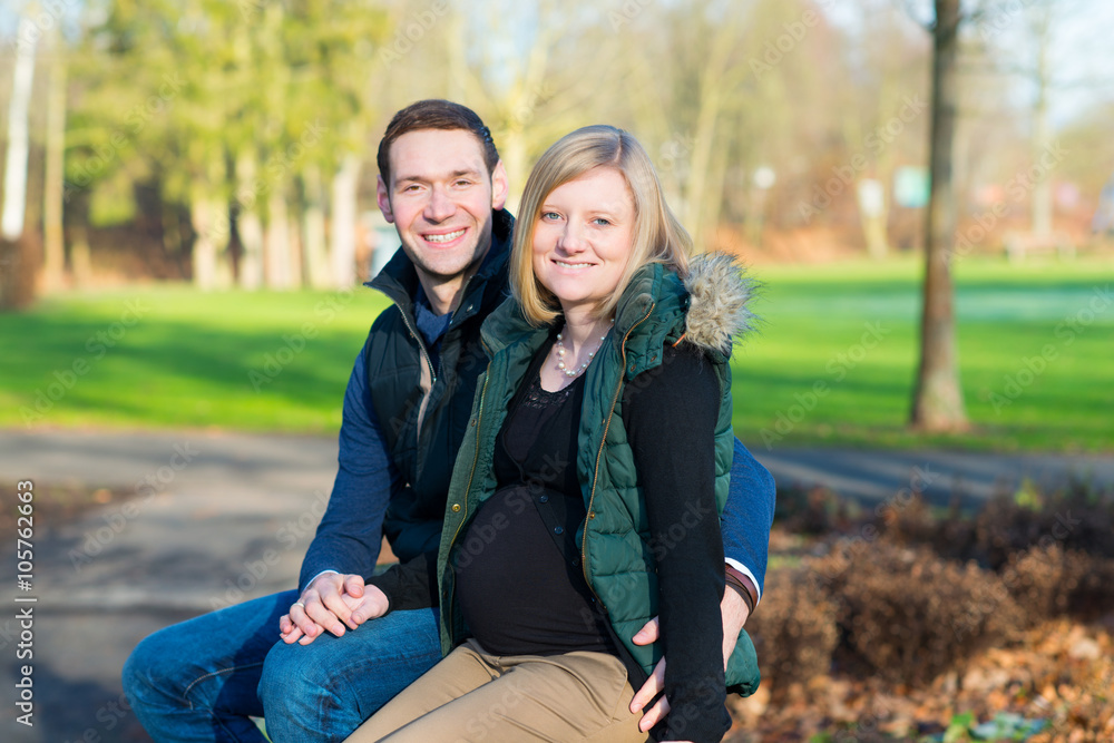 Fototapeta premium man and his pregnant wife in the park