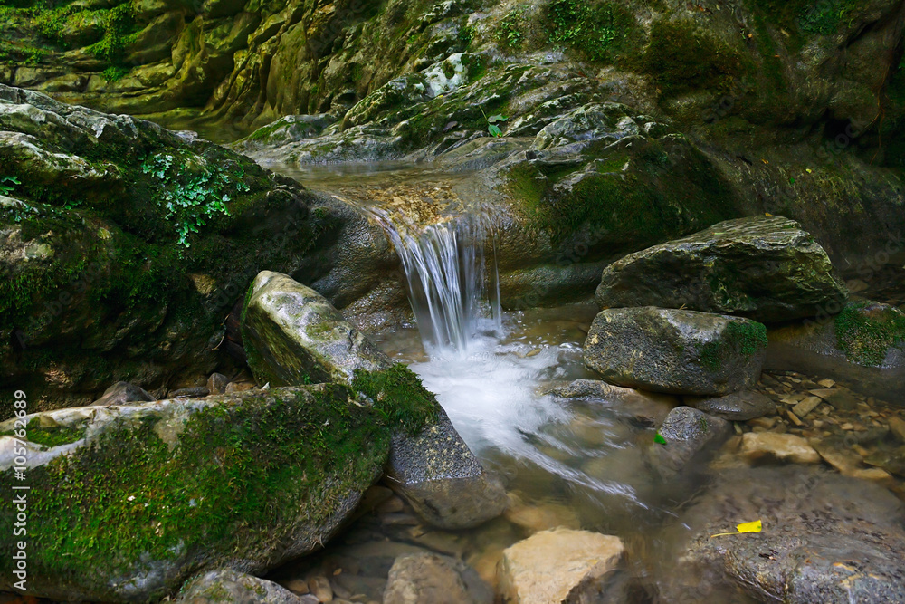 Beautiful flow of water flowing between the stones Beautiful flow of water flowing between the stones