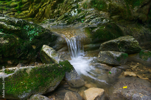 Beautiful flow of water flowing between the stones