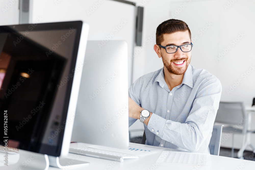 Male office worker sitting at desk Male office worker sitting at desk