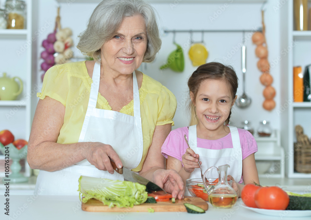 Senior woman with granddaughter cooking Senior woman with granddaughter cooking