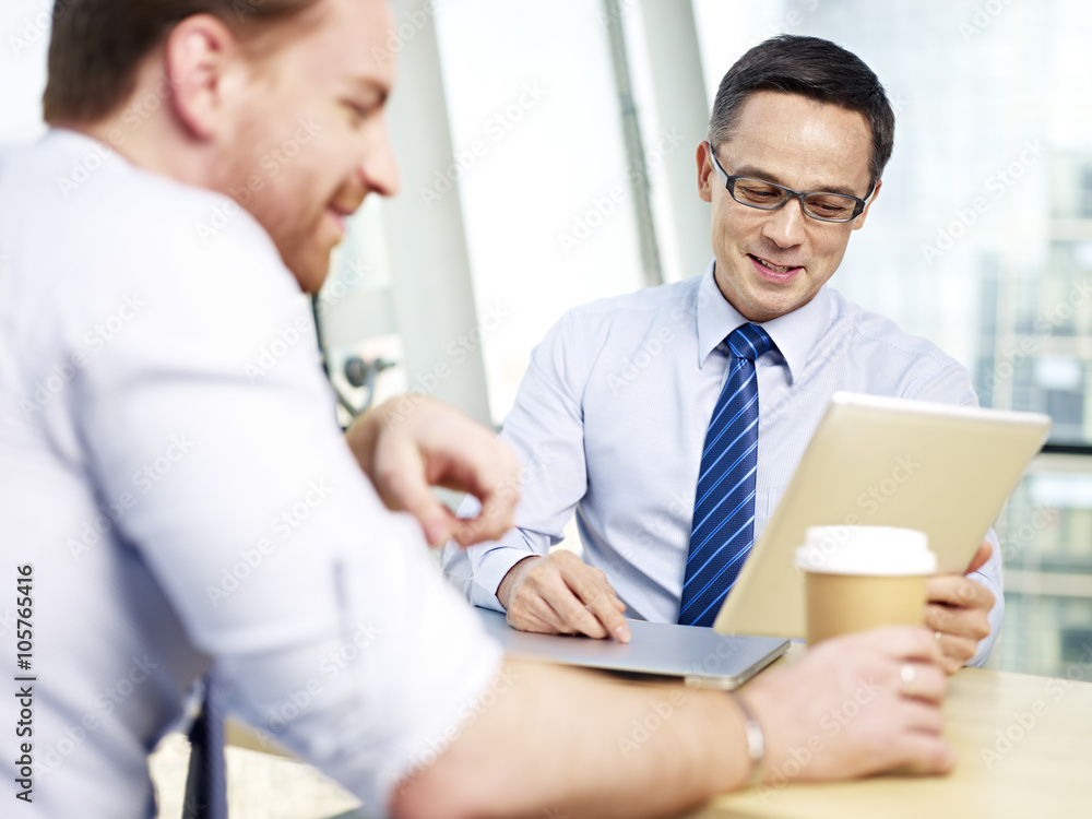 two business executive talking in office two business executive talking in office