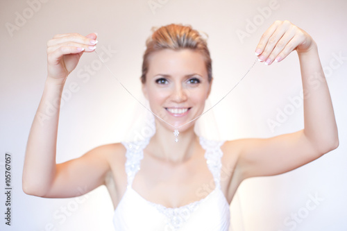 Cheerful bride holding a wedding gift