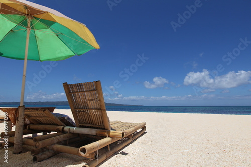 Fototapeta Naklejka Na Ścianę i Meble -  Chairs with parasol on beach