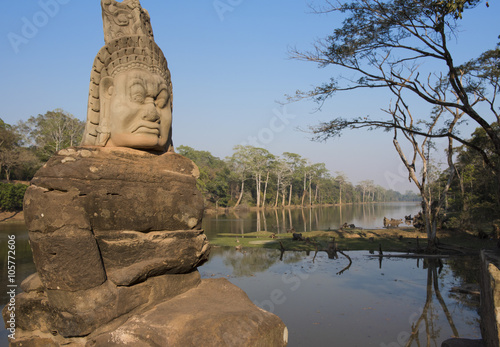 Demon on the Causeway to the South Gate of Angkor Thom showing a part of the enormous 12km moat around the city built by King Jayavarman VII 1190-1210