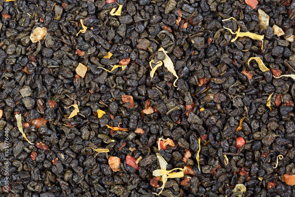 The composition of green tea (gunpowder tea) with slices of stra The composition of green tea (gunpowder tea) with slices of stra