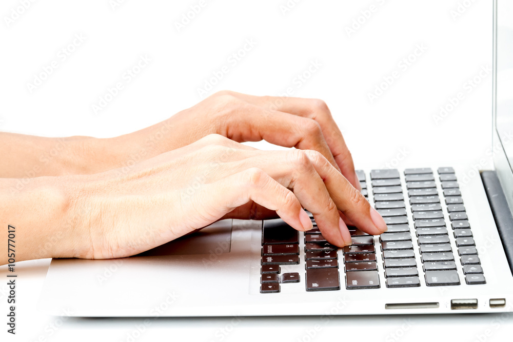 woman hand typing on the laptop on white table woman hand typing on the laptop on white table