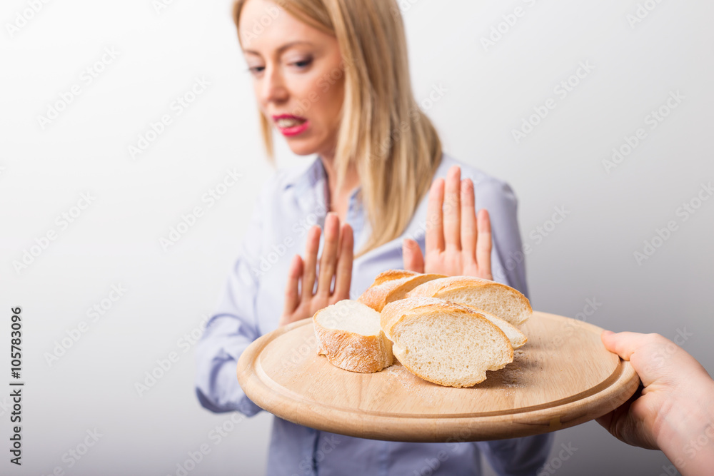 Woman refusing to eat bread - obrazy, fototapety, plakaty 