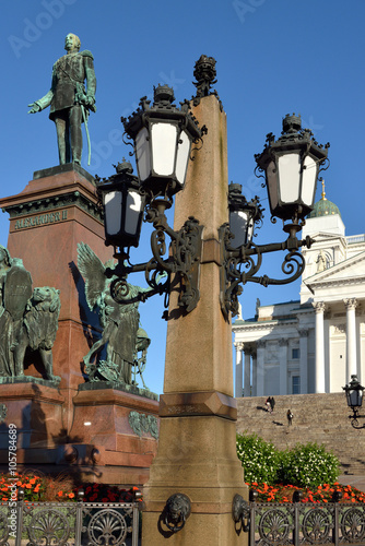 Lanterns of monument of Emperor Alexander II are located in center of Senate Square in Helsinki