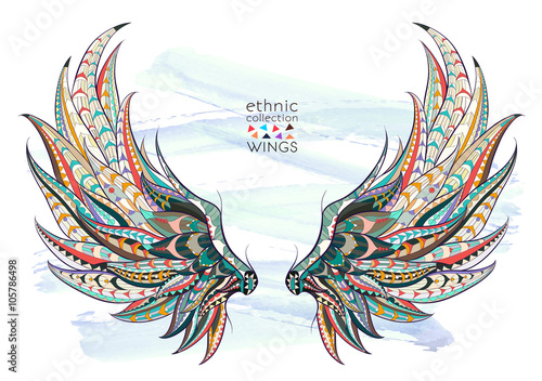 Patterned wings on the grunge background. African / indian / totem / tattoo design. It may be used for design of a t-shirt, bag, postcard, a poster and so on.  