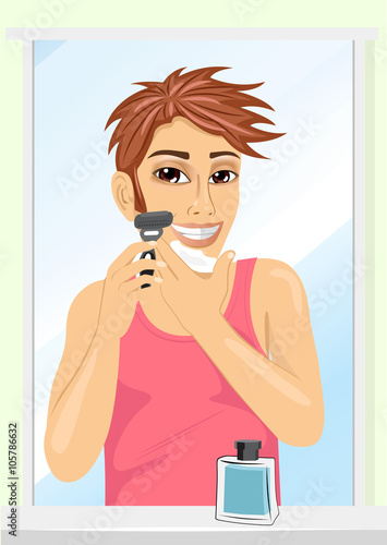 Portrait of young handsome man shaving