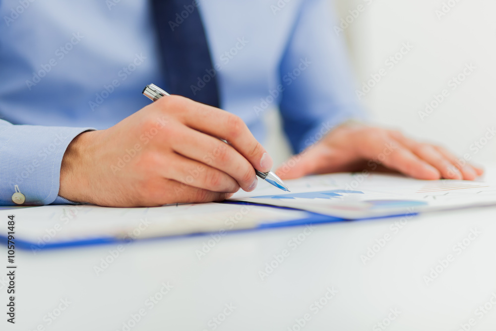 Businesswoman sitting at office desk signing a contract Businesswoman sitting at office desk signing a contract