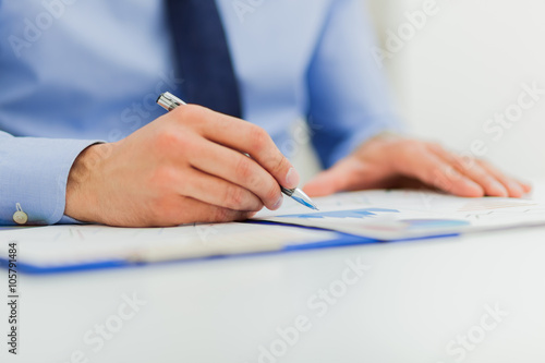 Fotografie Businesswoman sitting at office desk signing a contract