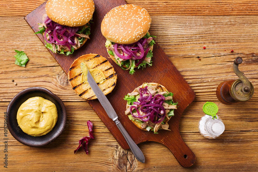 Burger with meat of duck with red onion and lettuce. Burger with meat of duck with red onion and lettuce.