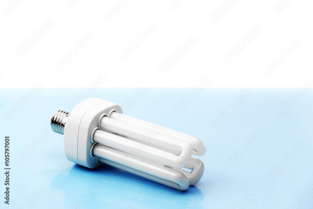 Energy saving bulb on blue and white background Energy saving bulb on blue and white background