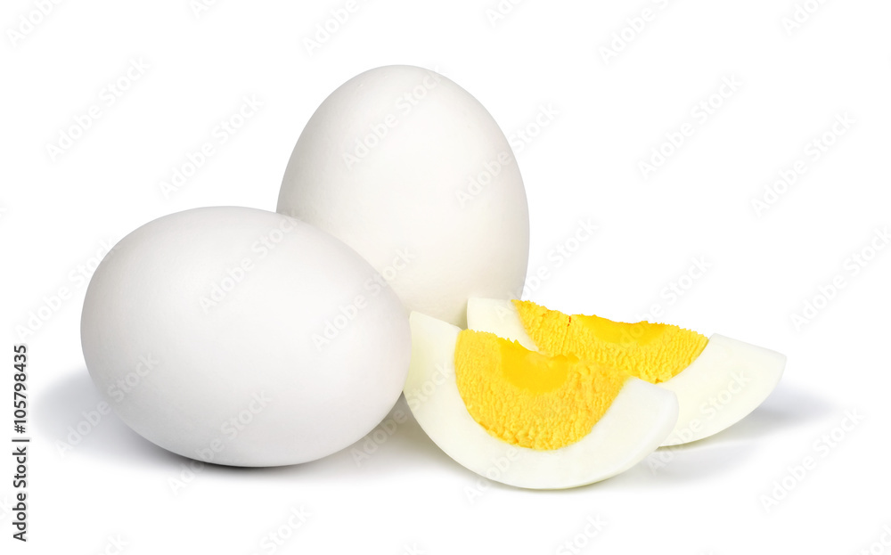 Two whole unpeeled boiled eggs and two slices of eggs isolated on a white background. Two whole unpeeled boiled eggs and two slices of eggs isolated on a white background.