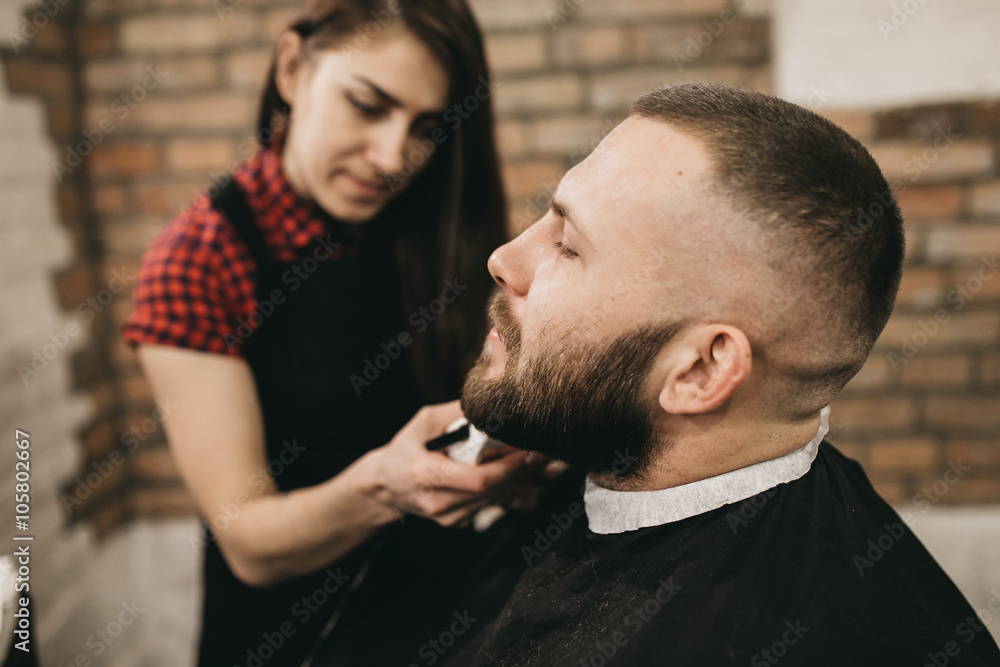 Bearded hipster client visiting barber shop Bearded hipster client visiting barber shop