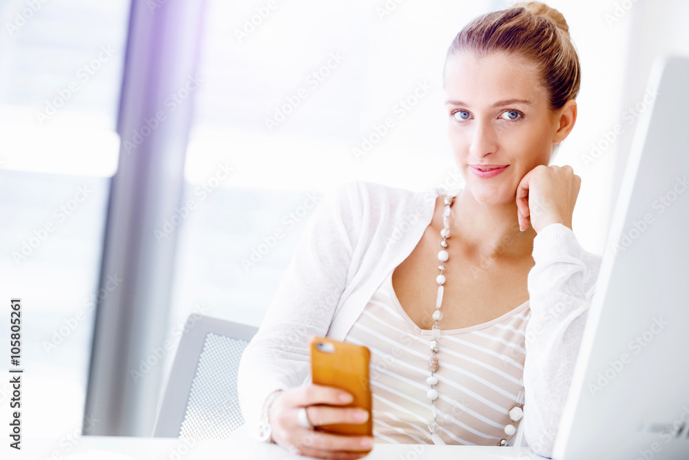 Attractive office worker sitting at desk Attractive office worker sitting at desk