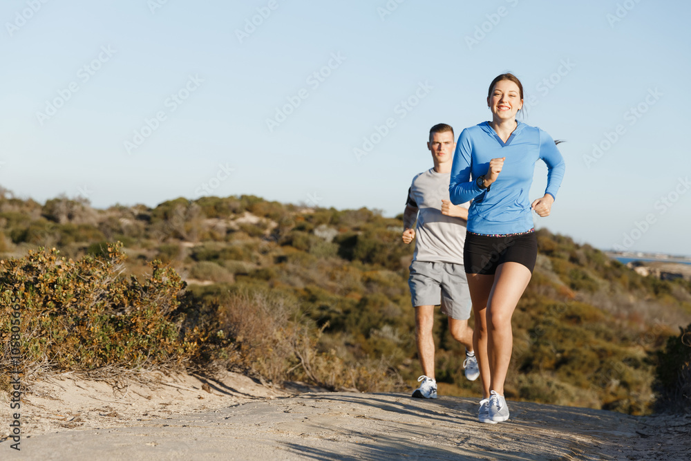 Sport runner jogging on beach working out with her partner Sport runner jogging on beach working out with her partner
