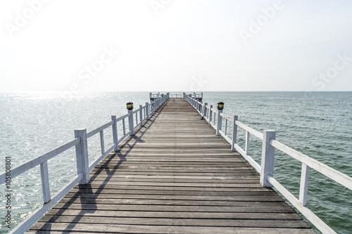 The wooden bridge walkway into the sea.