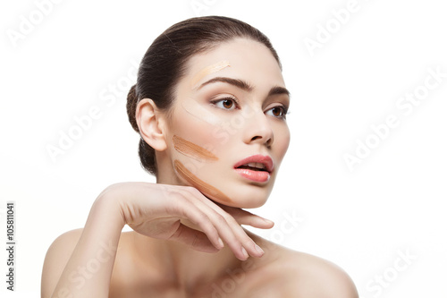 Girl with foundation cream on face
