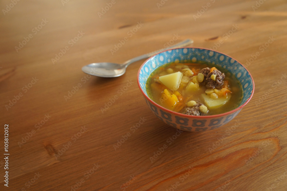 pea soup with meatball on wooden surface pea soup with meatball on wooden surface