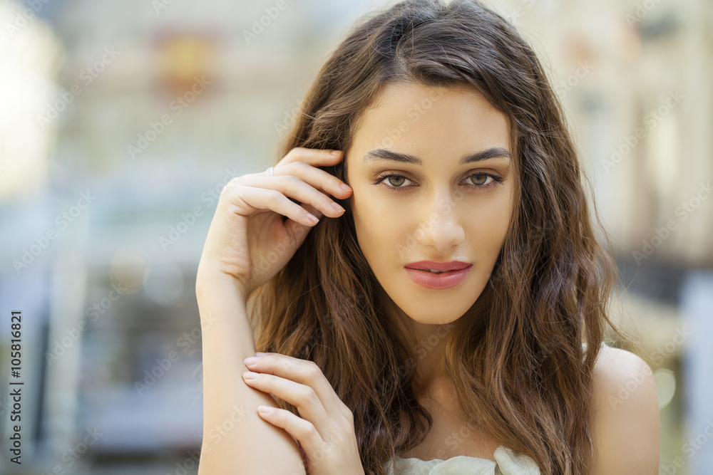 Portrait close up of young beautiful brunette woman in beige dre Portrait close up of young beautiful brunette woman in beige dre