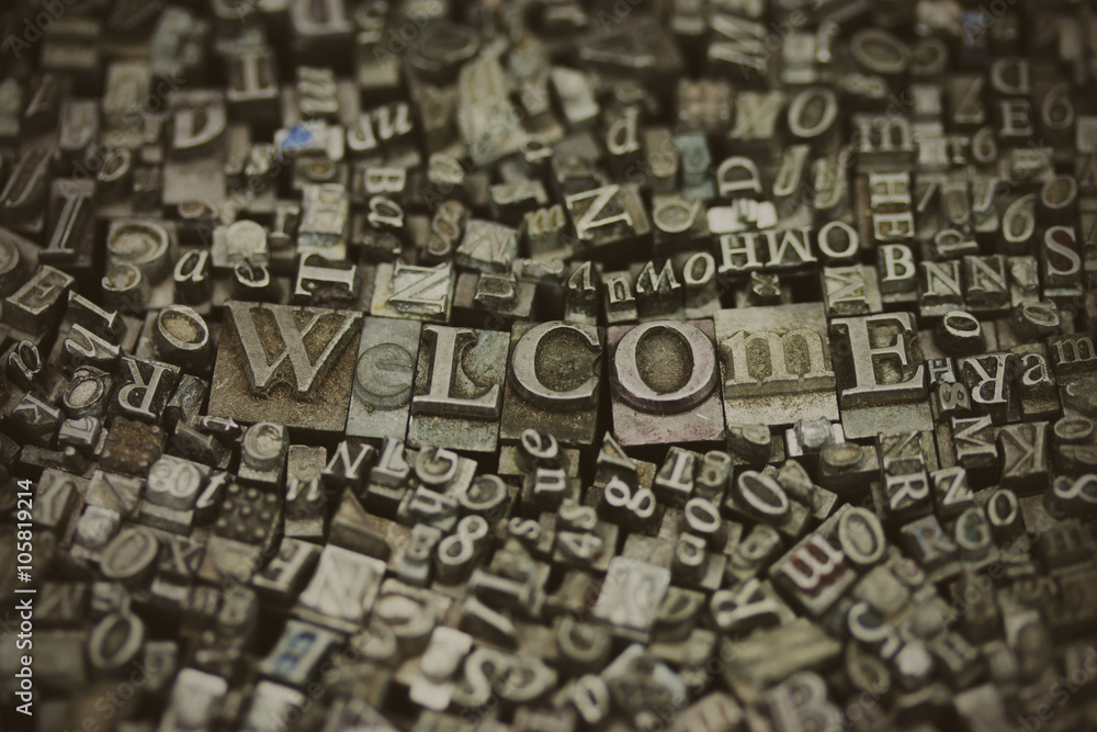 Close up of typeset letters with the word Welcome