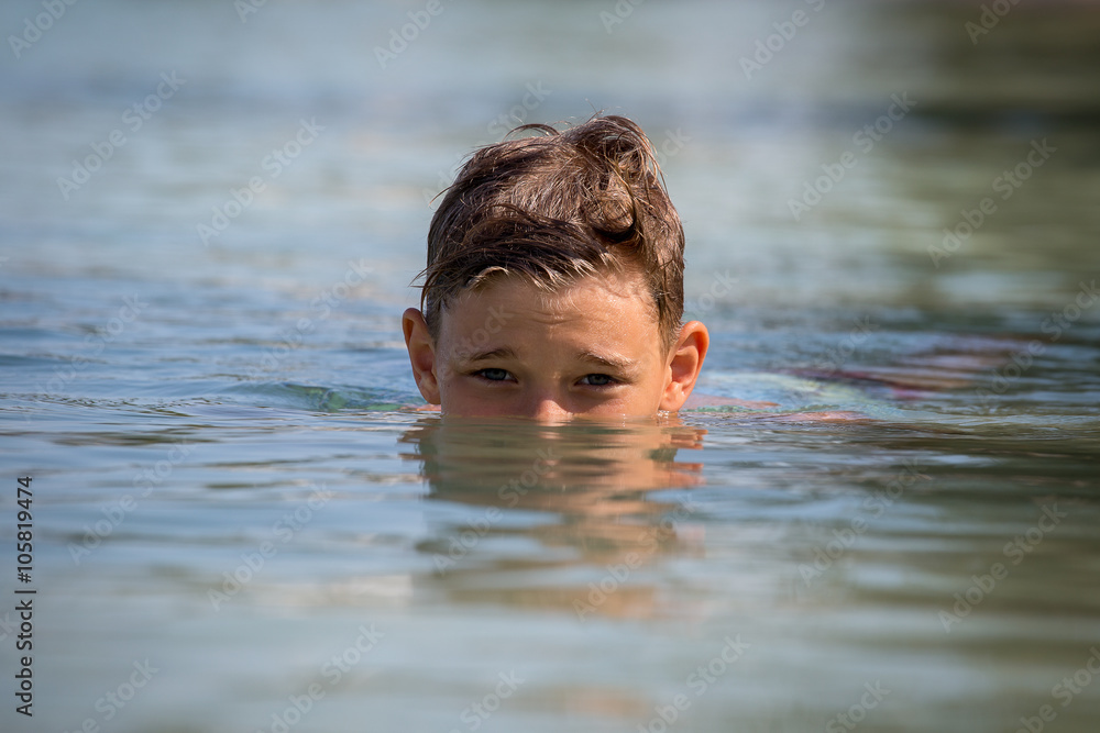 Happy teenager in sea water, close up