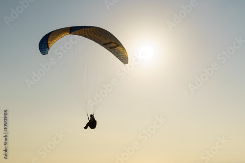 Paraglide silhouette over sea