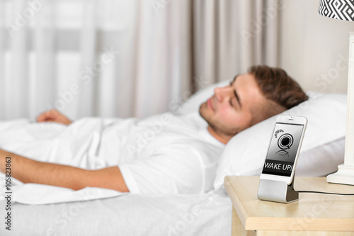 Handsome man waking up with...
