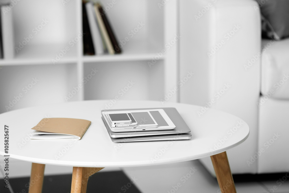Pile of electronic gadgets on the table. Communication and technology concept Pile of electronic gadgets on the table. Communication and technology concept