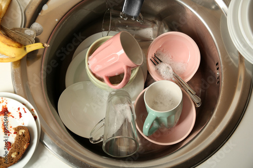 Dirty dishes in kitchen sink closeup