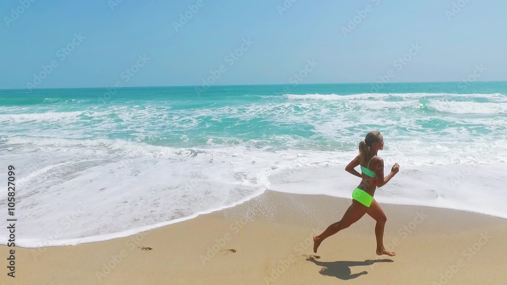 Running woman. Female runner jogging during outdoor workout on beach. Beautiful fit mixed race Fitness model outdoors. Running woman. Female runner jogging during outdoor workout on beach. Beautiful fit mixed race Fitness model outdoors.