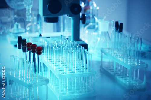 Microscope and different test tubes and flasks in laboratory