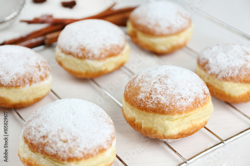 Fresh homemade donuts with powdered sugar, close up © Africa Studio