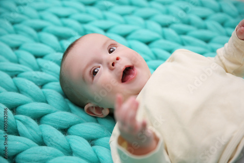 Lovely baby on knitted turq...