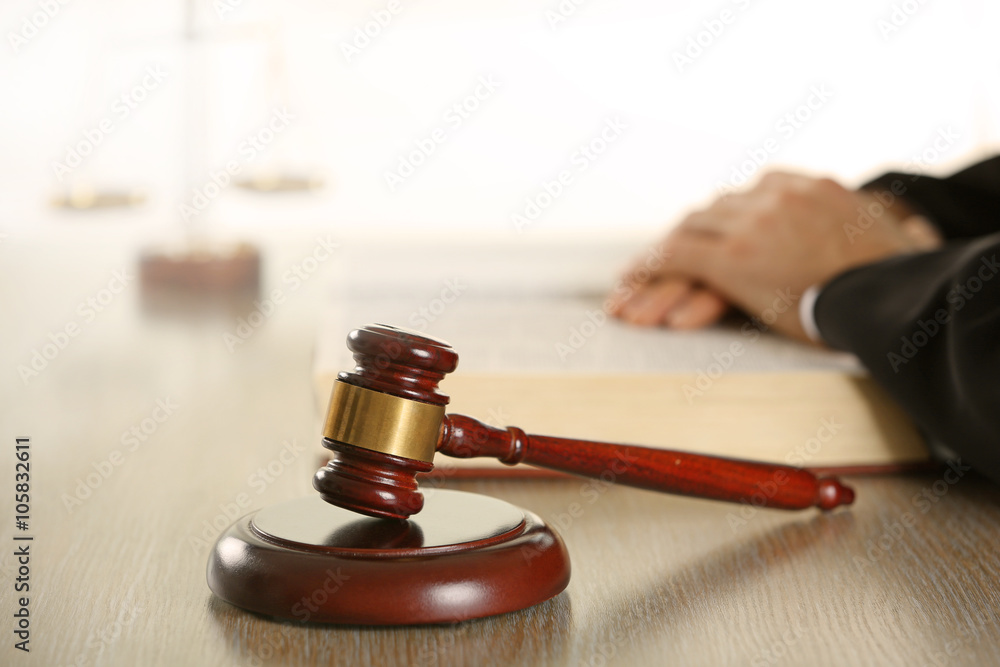 Judge reading book at wooden table indoors Judge reading book at wooden table indoors