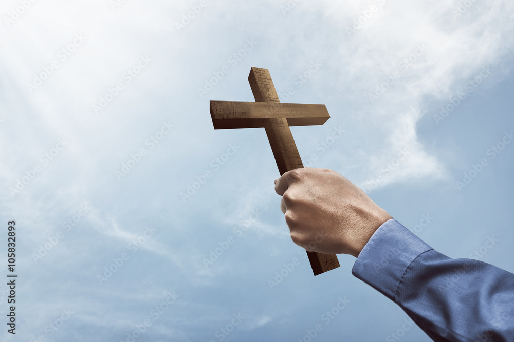 Fototapeta premium Human hand holding christian cross