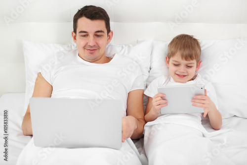 Father and son with laptop ...