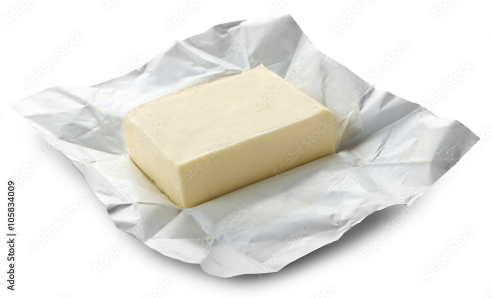 Piece of butter on paper, closeup