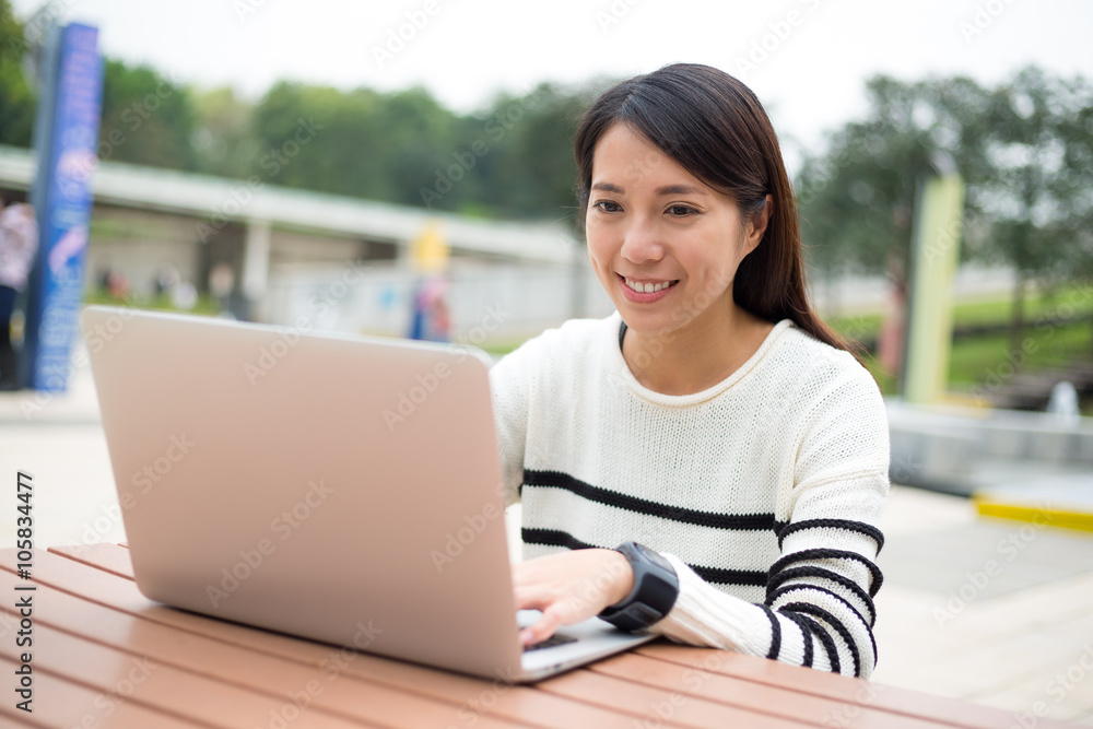 Woman typing on laptop computer with smart watch Woman typing on laptop computer with smart watch