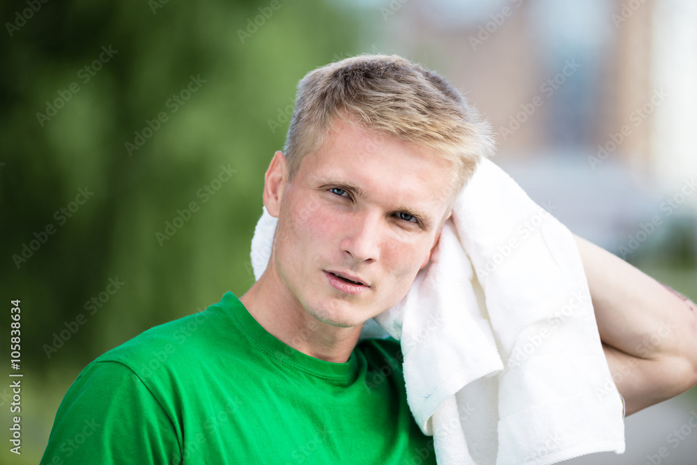 Tired man after fitness time and exercising. With white towel Tired man after fitness time and exercising. With white towel