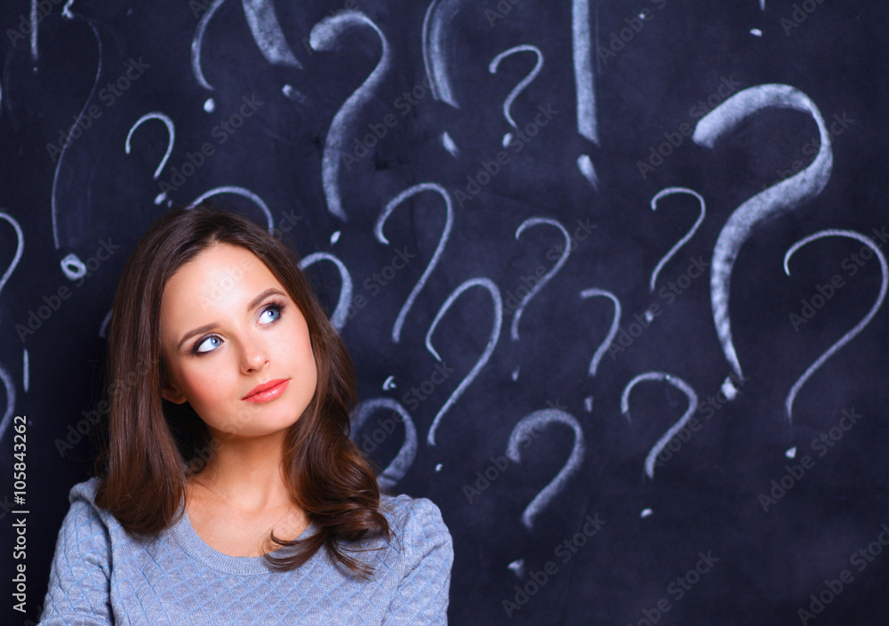 Young girl with question mark on a gray background Young girl with question mark on a gray background