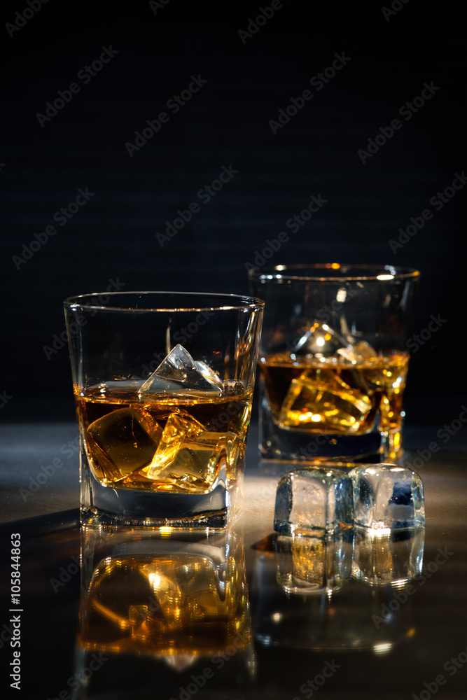 Glasses of whiskey with ice cubes Glasses of whiskey with ice cubes