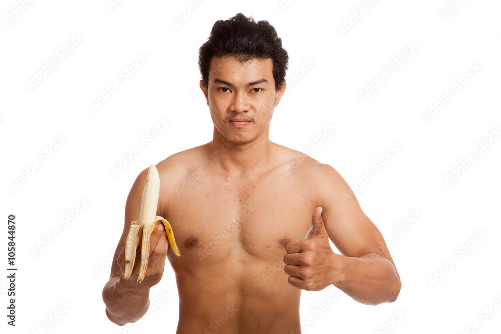 Muscular Asian man with banana show thumbs up